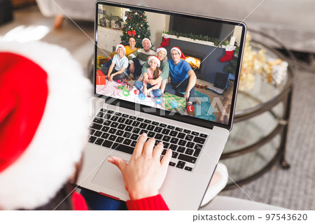 Caucasian woman having christmas video call with caucasian family Caucasian woman having christmas video call with caucasian family 97543620