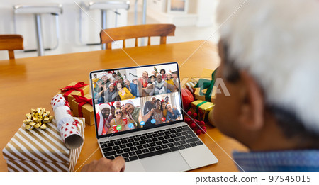 Biracial man with santa hat having video call with happy diverse friends Biracial man with santa hat having video call with happy diverse friends 97545015