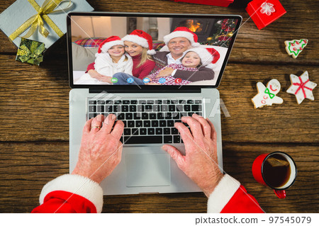 Santa claus with christmas presents having video call with happy caucasian family Santa claus with christmas presents having video call with happy caucasian family 97545079