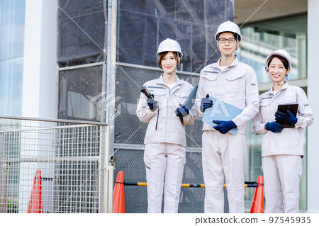 Worker taking measurements at a construction site 97545935