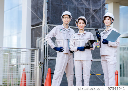Worker taking measurements at a construction site 97545941