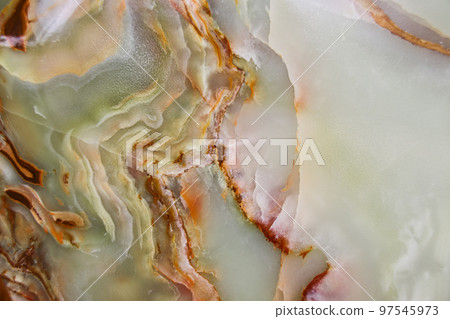 Close up of the pattern and color of the surface of a raw jade stone 97545973