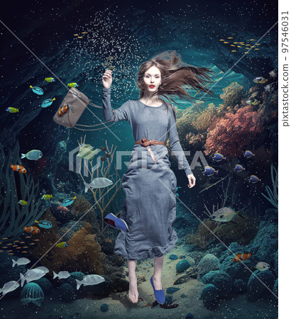 girl swims through the underwater landscape 97546031