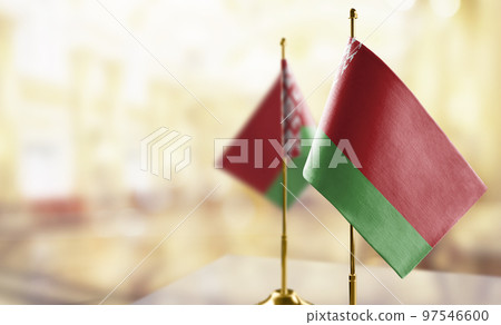 Small flags of the Belarus on an abstract blurry background 97546600