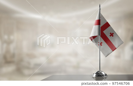 A small Georgia flag on an abstract blurry background A small Georgia flag on an abstract blurry background 97546706