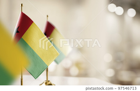 Small flags of the Guinea Bissau on an abstract blurry background 97546713