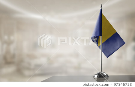 A small Bosnia and Herzegovina flag on an abstract blurry background 97546738