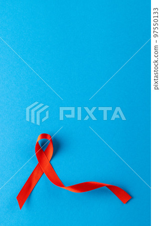 Composition of red ribbon on blue background 97550133