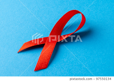 Composition of red ribbon on blue background Composition of red ribbon on blue background 97550134