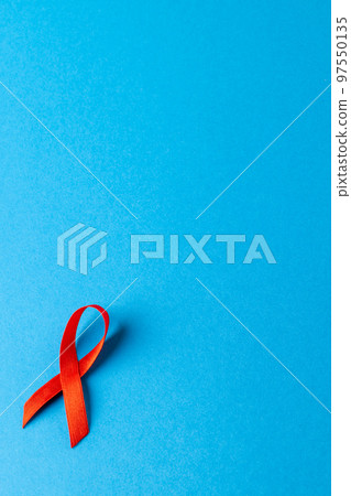 Composition of red ribbon on blue background 97550135