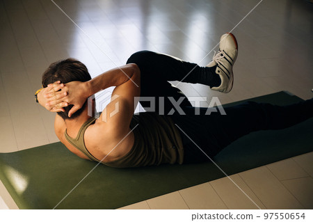 Man doing abdominal muscle training and bicycle crunch Man doing abdominal muscle training and bicycle crunch 97550654
