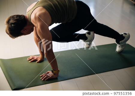 Man doing abdominal muscle training mountain climber Man doing abdominal muscle training mountain climber 97551356