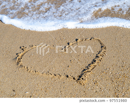 A heart drawn on the beach. 97551980