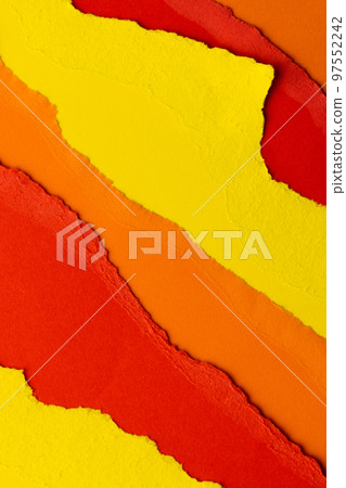 Ripped up pieces of coloured paper with copy space 97552242