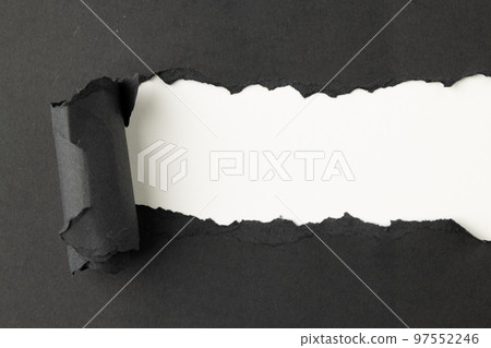 Ripped up piece of black paper with copy space on white background 97552246