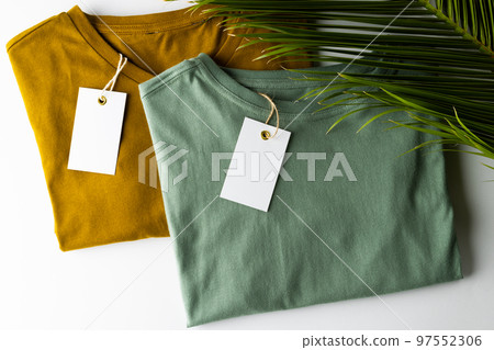 Close up of tshirts with tags and copy space on white background Close up of tshirts with tags and copy space on white background 97552306