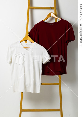 Tshirts displayed on ladder and copy space on white background Tshirts displayed on ladder and copy space on white background 97552355