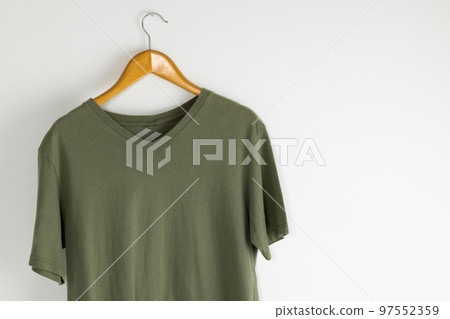 Tshirt hanging on coat hanger and copy space on white background Tshirt hanging on coat hanger and copy space on white background 97552359