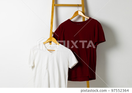 Tshirts displayed on ladder and copy space on white background Tshirts displayed on ladder and copy space on white background 97552364