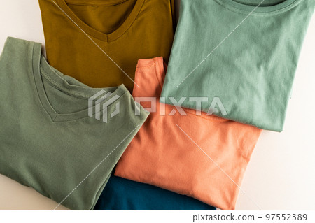 Close up of coloured tshirts and copy space on white background Close up of coloured tshirts and copy space on white background 97552389