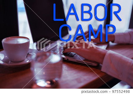 Text caption presenting Labor Camp. Business approach a penal colony where forced labor is performed 97552498