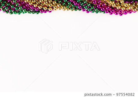 Composition of colourful mardi gras beads with copy space on white background with copy space Composition of colourful mardi gras beads with copy space on white background with copy space 97554082