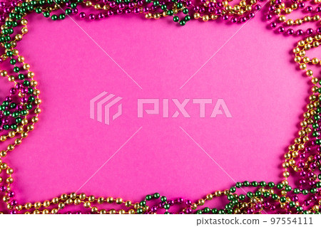 Composition of colourful mardi gras beads on pink background with copy space 97554111