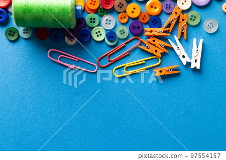 Composition of sewing equipment on blue background with copy space Composition of sewing equipment on blue background with copy space 97554157