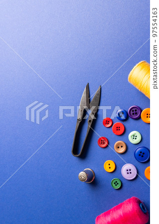 Composition of sewing equipment on blue background with copy space Composition of sewing equipment on blue background with copy space 97554163