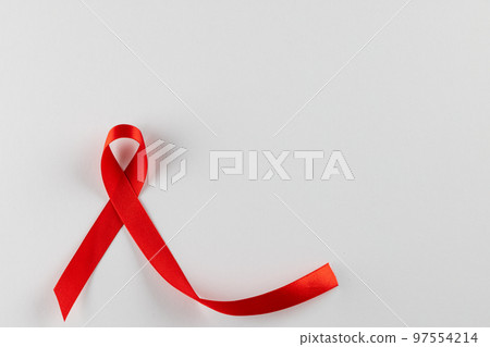 Composition of red ribbon for hiv or aids awareness, on white background with copy space Composition of red ribbon for hiv or aids awareness, on white background with copy space 97554214