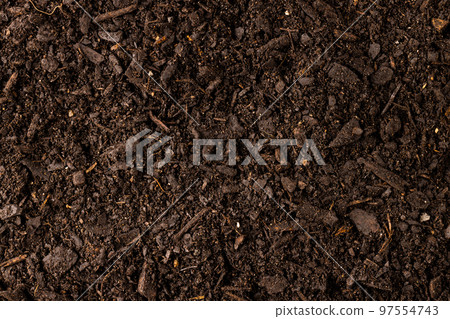 Full frame of dark rich peat soil and bark pieces 97554743