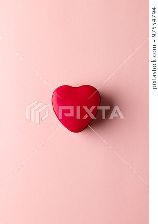 Overhead vertical image of red heart shaped box on pale pink background with copy space Overhead vertical image of red heart shaped box on pale pink background with copy space 97554794