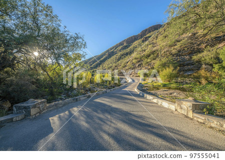 Sabino Canyon hiking trail along scenic mountains on a sunny day with blue sky Sabino Canyon hiking trail along scenic mountains on a sunny day with blue sky 97555041