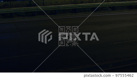 QR code scanner against light trails on black background 97555462