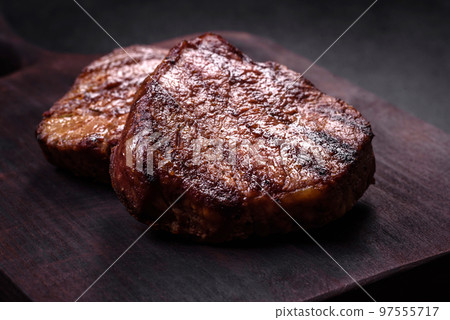 Delicious fresh juicy beef steak with spices and herbs Delicious fresh juicy beef steak with spices and herbs 97555717