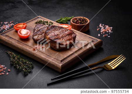 Delicious fresh juicy beef steak with spices and herbs 97555734