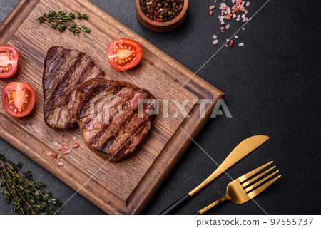 Delicious fresh juicy beef steak with spices and herbs 97555737
