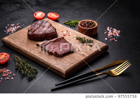 Delicious fresh juicy beef steak with spices and herbs Delicious fresh juicy beef steak with spices and herbs 97555738