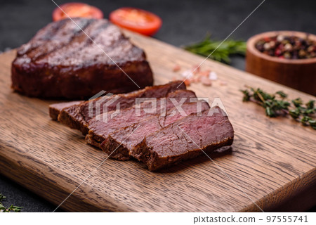 Delicious fresh juicy beef steak with spices and herbs Delicious fresh juicy beef steak with spices and herbs 97555741
