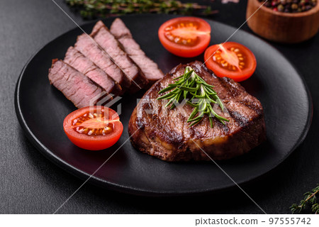 Delicious fresh juicy beef steak with spices and herbs Delicious fresh juicy beef steak with spices and herbs 97555742