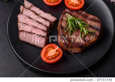 Delicious fresh juicy beef steak with spices and herbs Delicious fresh juicy beef steak with spices and herbs 97555746