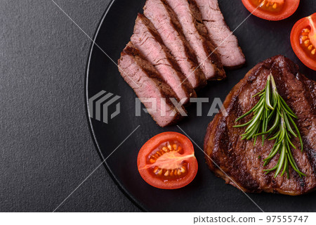 Delicious fresh juicy beef steak with spices and herbs Delicious fresh juicy beef steak with spices and herbs 97555747
