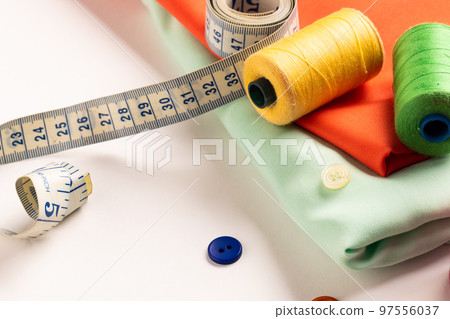 Composition of sewing equipment on white background Composition of sewing equipment on white background 97556037