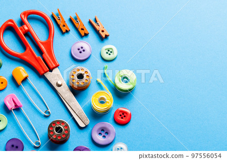 Composition of sewing equipment on blue background Composition of sewing equipment on blue background 97556054