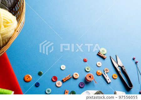 Composition of sewing equipment on blue background Composition of sewing equipment on blue background 97556055