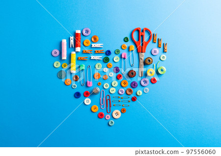 Composition of sewing equipment on blue background 97556060