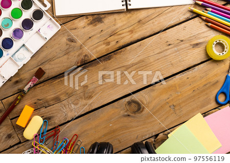 Composition of painting equipment and headphones on wooden background Composition of painting equipment and headphones on wooden background 97556119