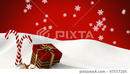 Image of snow falling over candy canes and christmas present on red background 97557205