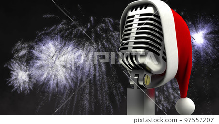 Image of santa hat on retro microphone with white christmas and new year fireworks in night sky 97557207