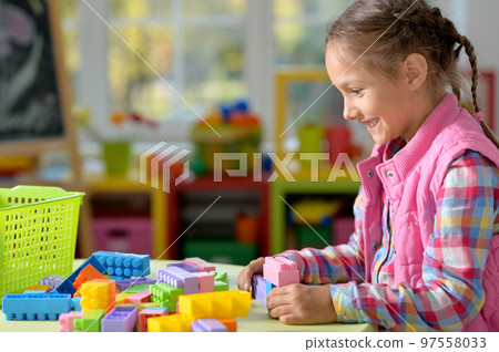 little girl playing at home 97558033